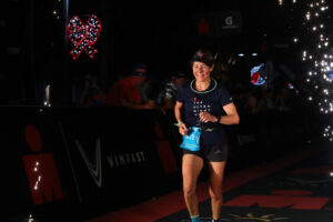 woman at race finish line in the dark