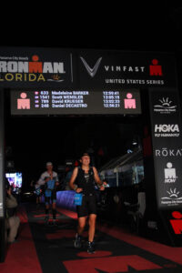 woman at race finish line in the dark