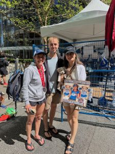 3 people post marathon one with sign